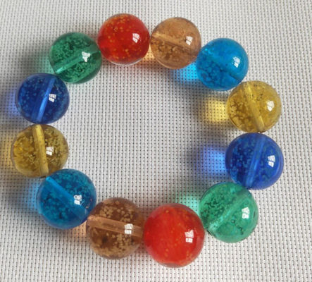 Fulgor nas cordas de vidro escuras da mão de cores diferentes
